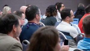 Attendees smiling and learning in a session