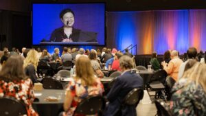 Leaders make announcements on the annual conference stage